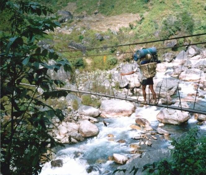 Nepalese Porter crossing Suspension Bridge across Kabeli Khola to Yamphudin